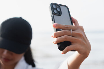 Close-up of Hand Holding Smart phone at Beach