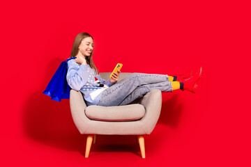 Photo of attractive charming woman wear stylish sweater new year online purchase isolated on red...
