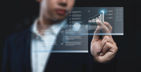 Businessman analyzing company's financial revenue and profit with value increasing charts, information computer system technology, using data to calculate business strategy, document share transfer.