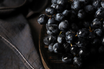 Grape on a wooden desk on the dark background 