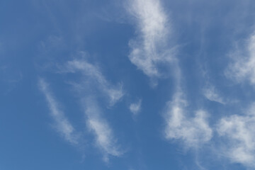 A beautiful display of wispy clouds drifting across a bright blue sky, inviting peaceful thoughts and reflections.