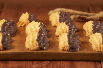 Homemade vanilla cookies, half covered in delicious bitter chocolate