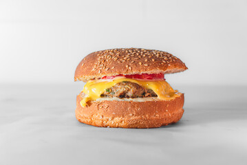 Close-up of burger on table against white background