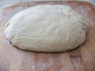 the baking dough is laid out on a board