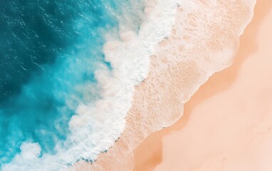 Aerial view of turquoise ocean water meeting a sandy beach.