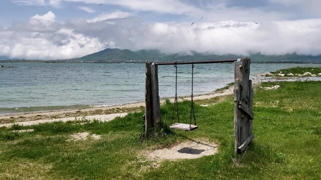 Tranquil Lakeside Swing on Beautyfull Natural View of Sevan Lake in Armenia