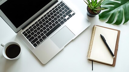 Office desk with a white table featuring a blank notebook computer supplies and a coffee cup Top view with space for text Flat lay composition