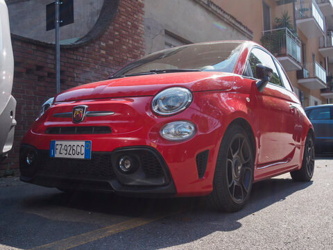 Red fiat 595 competizione parked on a city street