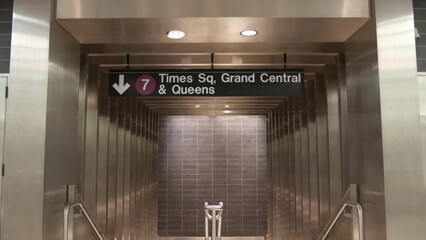 New York subway station interior. Text sign: Times Square, Grand Central, Queens . Manhattan...