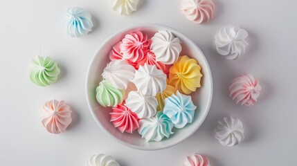 A bowl of colorful meringues with a white background