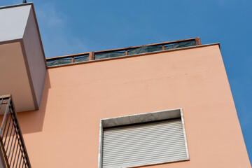 Crack running along the exterior of a building being renovated, with a wooden structure built on the rooftop