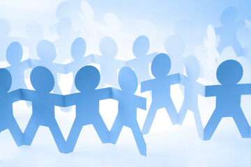 Team of paper chain people united together holding hands