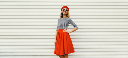 Beautiful happy smiling young woman, pretty girl in red skirt, french beret, heart shaped glasses