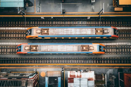 Aerial View of Two Orange and Blue Trains on Railway Tracks at Station