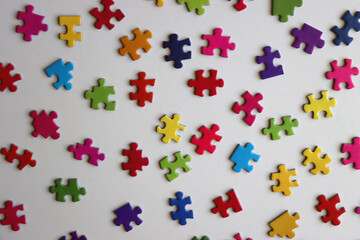 Colorful jigsaw puzzle pieces on white background. Flat lay.