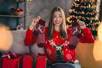 Photo of lovely cheerful girl dislike socks shopping dressed red christmas garment tradition...