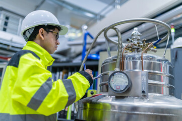 Asian engineer working at Operating hall,Thailand people wear helmet  work,He worked with diligence...