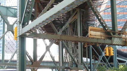 New York elevated subway, metropolitan bridge, metro track above street. Railway transport over road. Queensboro railroad train line. Queens Plaza public transportation. Long Island city United States