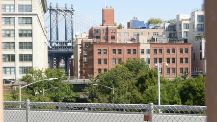 New York City Manhattan Bridge view from Brooklyn Bridge. Red brown brick residential building...