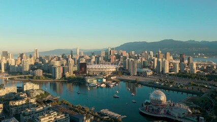 An aerial approach shot of sunny downtown Vancouver from the southeast