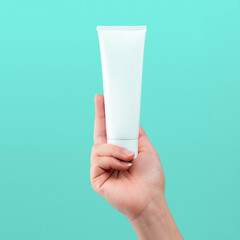 White Blank Lotion Tube on Hand isolated background