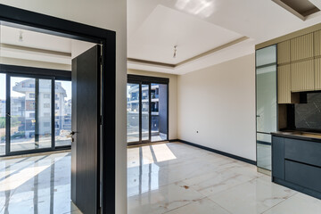 Empty house interior with wide glass pane windows letting in a lot of light