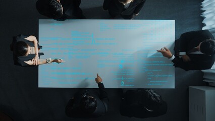 Top down aerial view of professional business team share idea about coding prompt or programing engineering code. Group of investor brainstorming strategy of data analysis at meeting. Directorate.