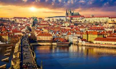 Obraz premium Prague, Czech Republic. Panoramic view at the famous antique Charles Bridge on river Vltava. Picturesque landscape with Prague Castle and sunset above old town houses.