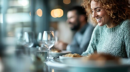 A smiling woman in a cozy setting enjoys an elegant dinner, capturing the essence of relaxation, contentment, and pleasure during a delightful evening meal.