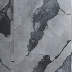 close-up view of a textured surface, likely a type of stone or concrete. The surface features a mix of gray tones with darker and lighter patches, creating a marbled effect