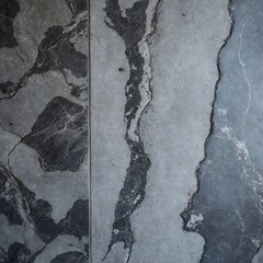 close-up view of a textured surface, likely a type of stone or concrete. The surface features a mix of gray tones with darker and lighter patches, creating a marbled effect
