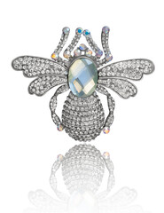 Jewelery pin with rhinestones in the form of a bug on a white background