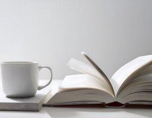 An open book and a coffee or tea cup on a white background, creating a tranquil morning vibe