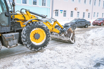 A snow plow is clearing the road of snow