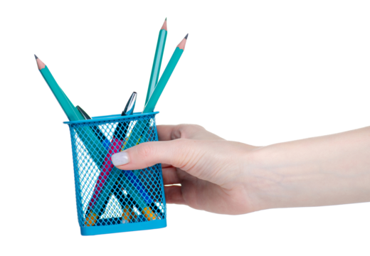 Hand holding pens and pencils in metal pot stand isolation