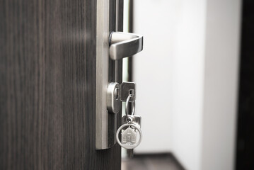 Open door with keys, key in keyhole