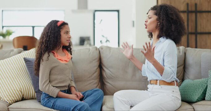 Mother, daughter and conflict with angry on sofa in living room for behaviour, tantrum and hand gesture. Family, woman and girl child with argument, discipline and frustrated with fighting and argue