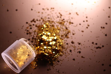 golden shiny glitter on a light brown background