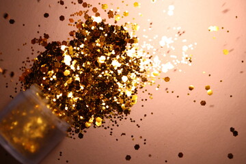 golden shiny glitter on a light brown background