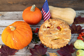 autumn Halloween composition of mummy pie, American flag and pumpkin