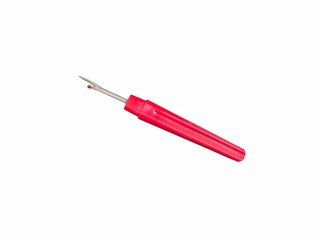 Seam ripper with red plastic handle isolated on white background. Plastic handle ripper stitch unpicker. Cotton thread craft sewing tool. Embroidery concept