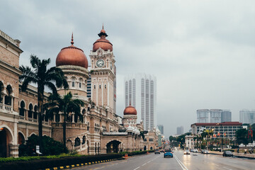 Sunrise over Kuala Lumpur showcasing the historical Sultan Abdul Samad Building and modern skyline...