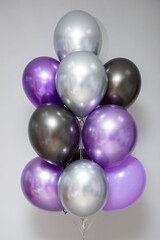 bunch of purple and black helium balloons, chrome balloons