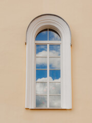 Fototapeta premium Images of clouds are reflected in the glass window of the building. Minimalism, inspiration and freedom of thought