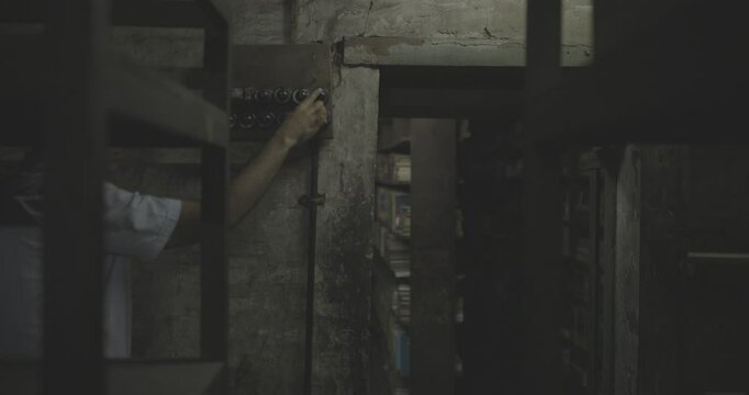Man turning on the switch of a very old factory shop, rustic, vintage,