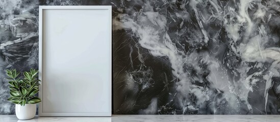 Empty white picture frame on a gray marble wall background. Copy space image. Place for adding text and design