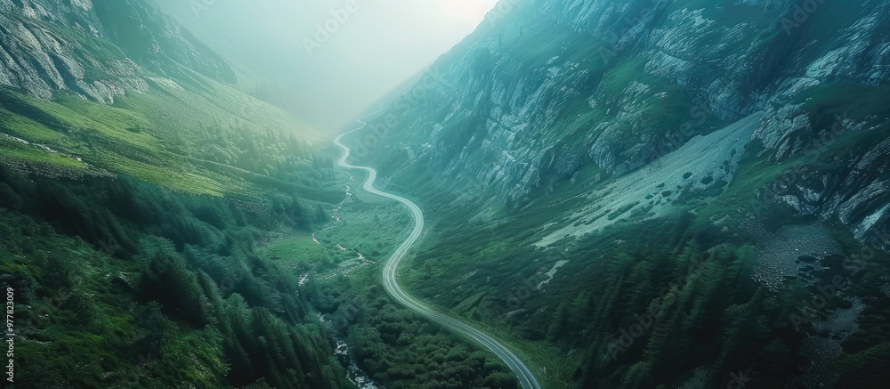 Aufkleber aerial perspective of a mountain road at sunrise with a winding asphalt path cutting through the mou