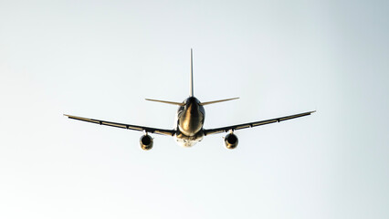 passenger airliner in the sky at sunset