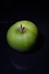 Green Granny smith apple isolated on dark background