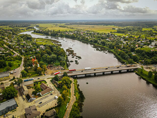 An aerial view of the Salacgriva bridge crossing the Salaca River. The scene includes the...